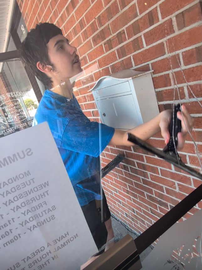 Reinhart Pastrana cleaning windows for NH Tint