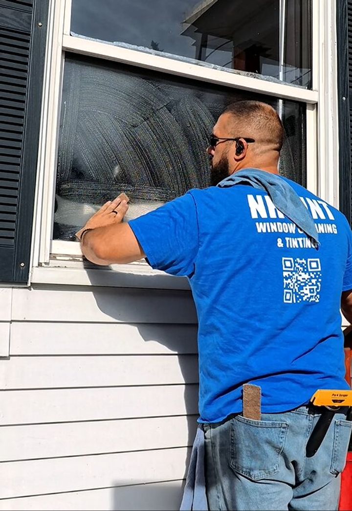 NH Tint cleaning a residential window