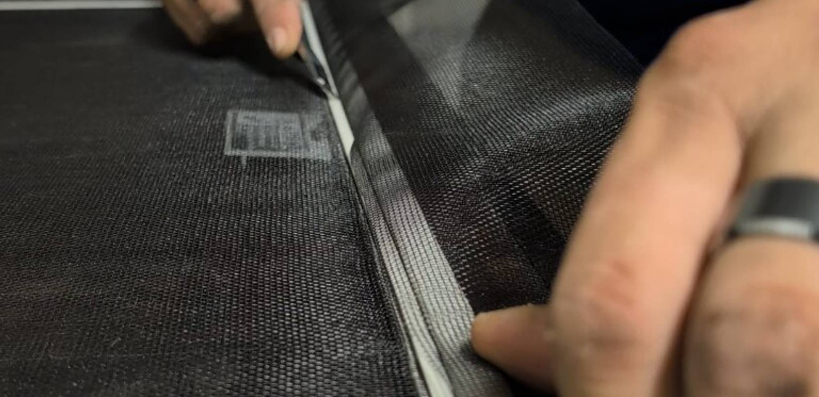 Rescreening a damaged window screen with fresh mesh and new spline.