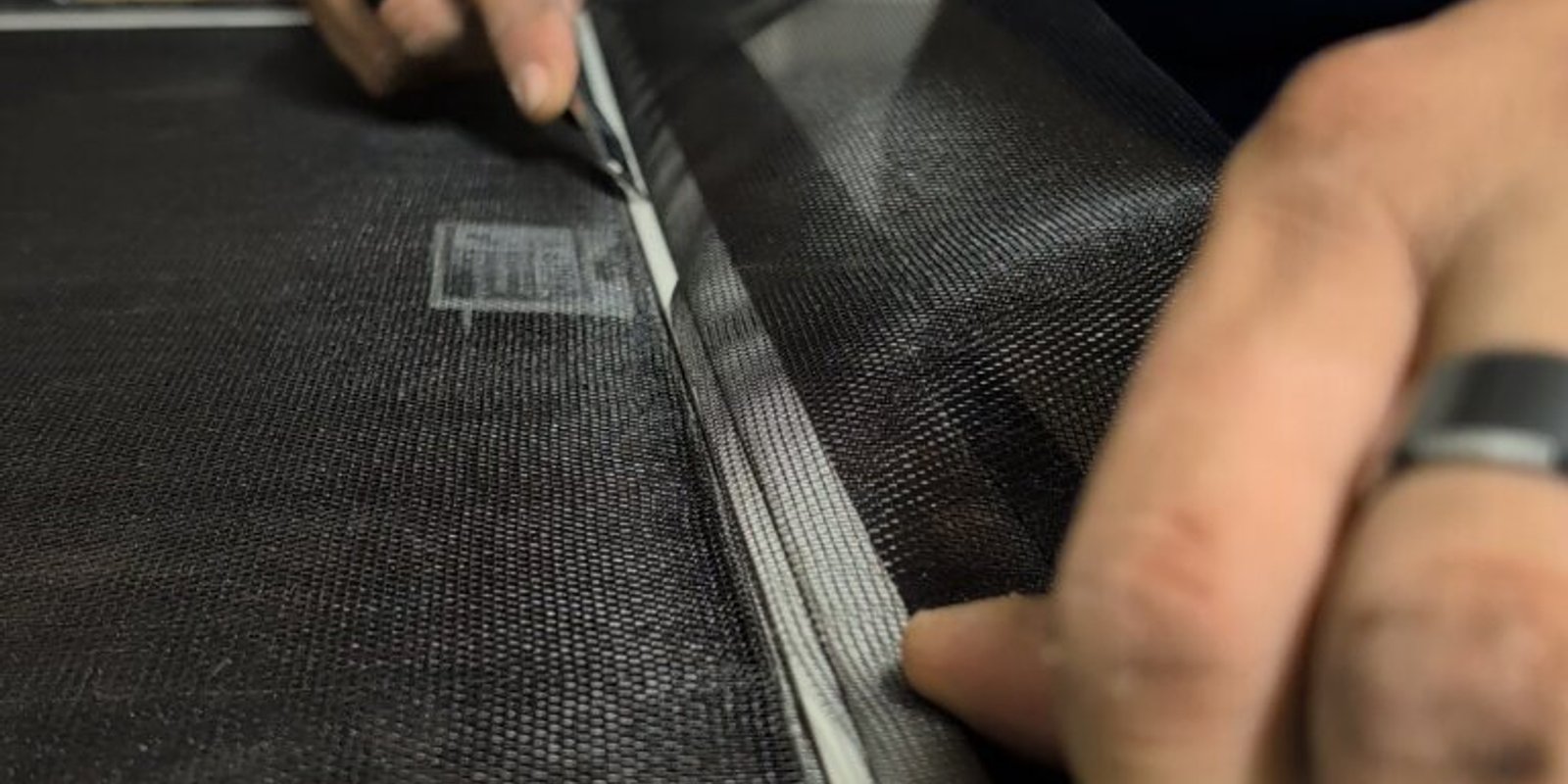 Rescreening a damaged window screen with fresh mesh and new spline.