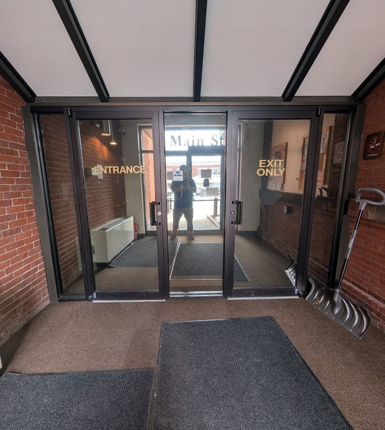 Security window film installed on a large glass surface